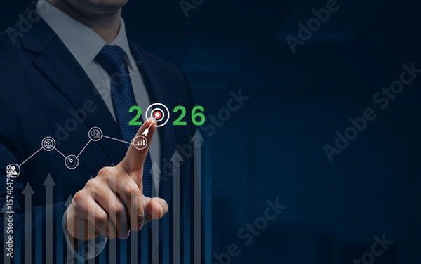 Fototapeta Businessman pointing at the year 2026 with a target and growth graph