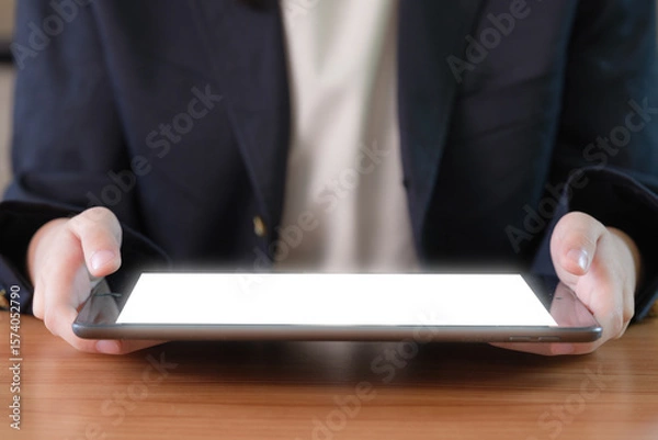 Fototapeta Close-up image of a businesswoman's hand using a digital tablet.