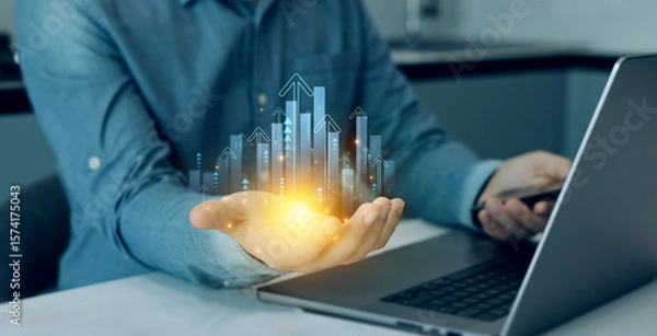 Fototapeta Businessman holding arrow up with graph corporate future growth plan.Business growth graph chart. Financial marketing graph grow chart.