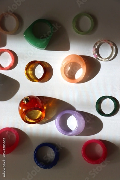 Obraz Collection of colorful plastic rings on white background. Top view.