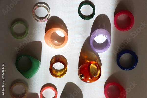 Obraz Collection of colorful plastic rings on white background. Top view.