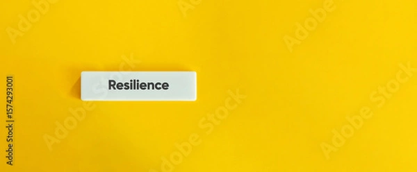 Fototapeta Resilience Concept on Minimal Letter Tile with Yellow Background