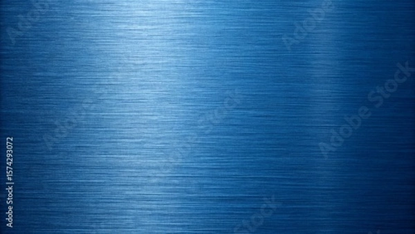 Fototapeta A blue metal surface with a brushed texture creates a cool, industrial background with subtle light reflections