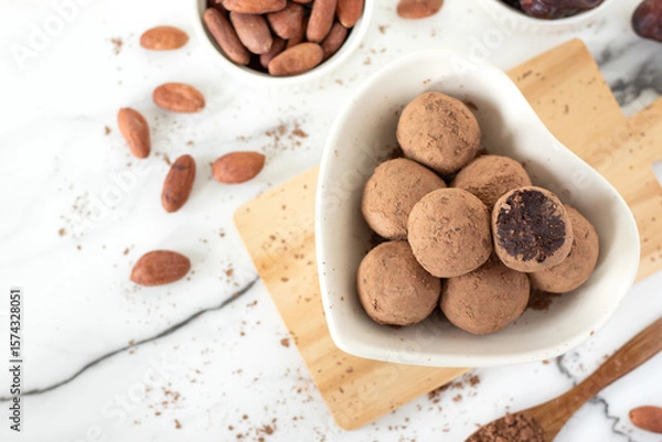 Obraz Chocolate truffles with dates and cocoa powder. Top view. Healthy homemade dessert or snack.