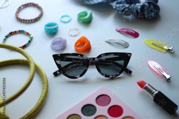 Obraz Green bag, various colorful jewelry, sunglasses, hair accessories and colorful make up on white background. Selective focus.