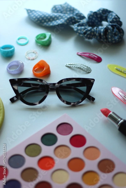 Obraz Green bag, various colorful jewelry, sunglasses, hair accessories and colorful make up on white background. Selective focus.