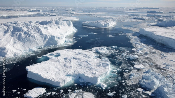 Fototapeta breathtaking aerial view of ocean surfaces bordered by pristine ice shores and majestic icebergs