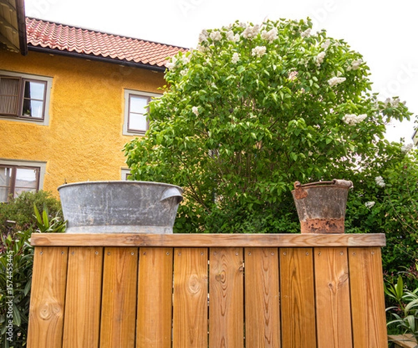 Fototapeta Rustic Garden Scene with Containers and Lush Greenery