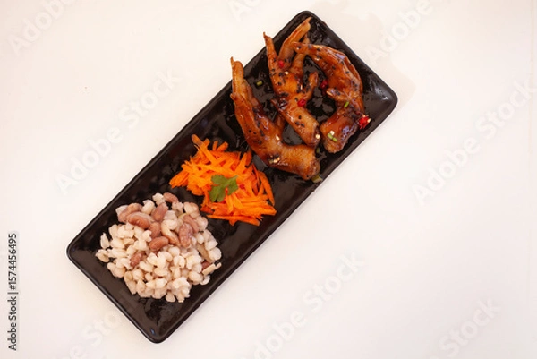 Obraz Sweet and spicy chicken feet with carrots and "samp"