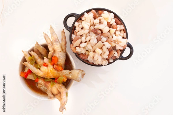 Obraz Chicken feet and 'samp' with beans on white