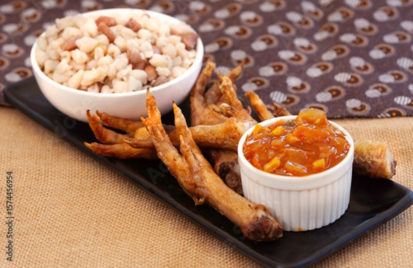 Obraz Fried chicken feet served with Chakalaka and samp