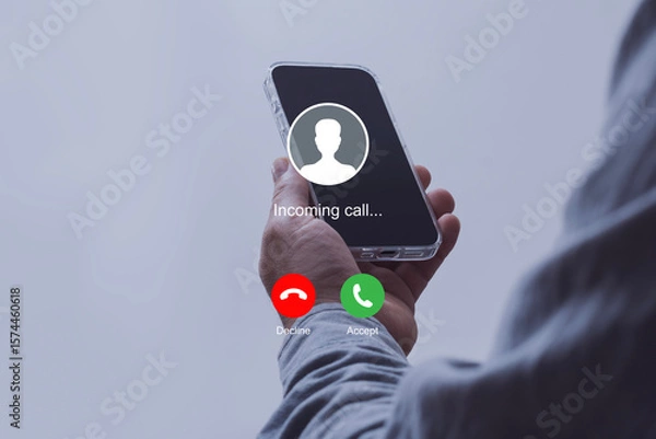 Obraz Notification of an incoming call on a smartphone held by a man wearing a shirt. Concept of mobile communication, telecommunication and incoming call notification.