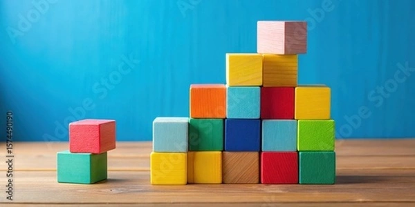 Fototapeta Colorful wooden blocks stacked high on a table