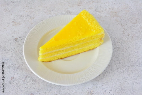 Obraz Slice of Lemon Cake on a Plate flat lay