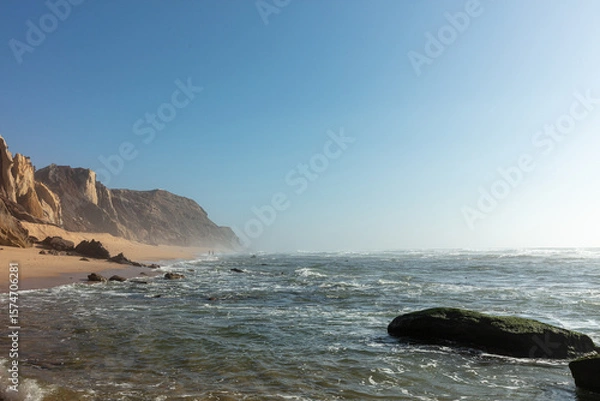 Fototapeta Dramatic Coastal Cliffs and Sandy Beach with Ocean Waves