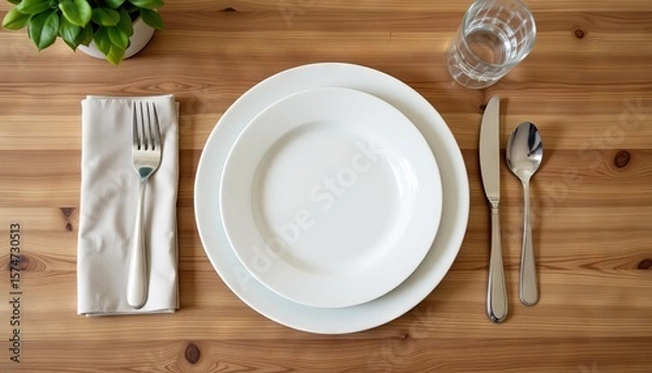 Obraz Table setting with white plates silverware napkin and glass on wooden table