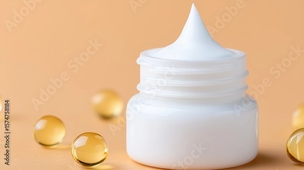 Obraz Elegant white bottle of cream surrounded by golden drops highlighting the luxurious texture and softness captured in a pastel focus