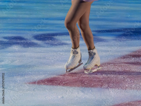 Fototapeta Detail of the Legs and Ice Skates of a Skater Executing his Artistic and Technical Performance on the Ice Rink
