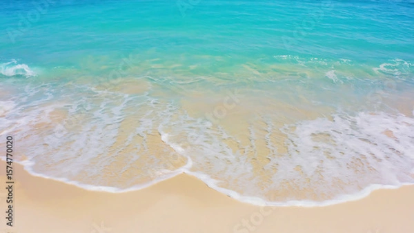 Fototapeta Aerial view of a serene beach with turquoise water and soft sand.