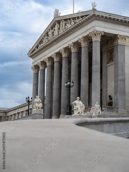 Fototapeta Facade of Neoclassical Parliament Building in Vienna with its Iconic Columns and Statues, Austria