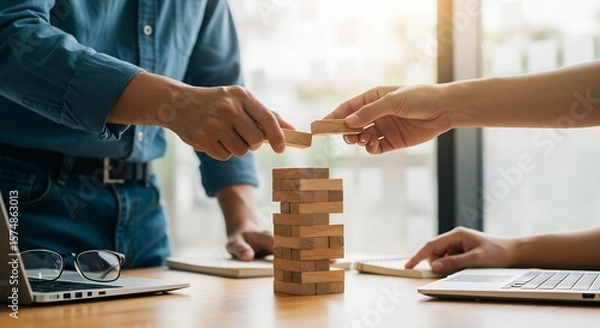 Fototapeta Collaborative Teamwork: Businesspeople Strategically Building a Wooden Block Tower, Representing Growth, Planning, and Risk Management
