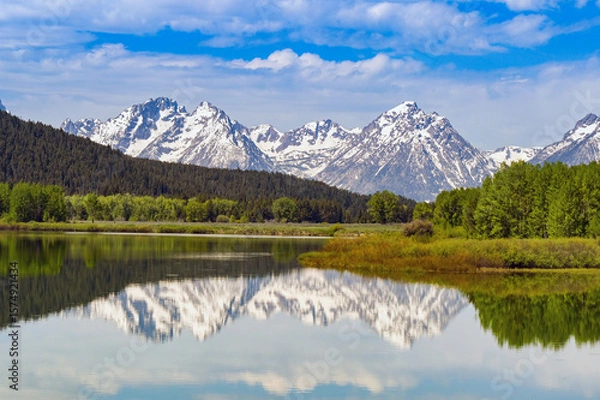 Obraz Scenic view of snow capped mountains in the Grand Teton National Park reflected in the still waters of a lake. No people.