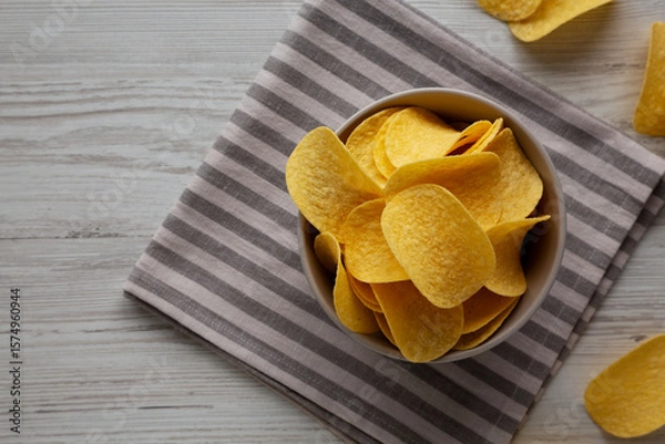 Fototapeta Potato Chips in a Bowl, top view. Flat lay, overhead, from above.