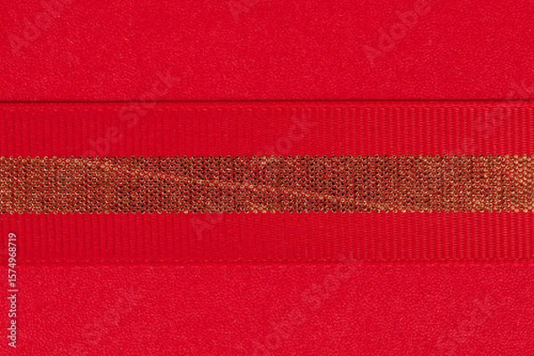 Obraz Bright red texture with shiny gold ribbon detail for crafts or decorations