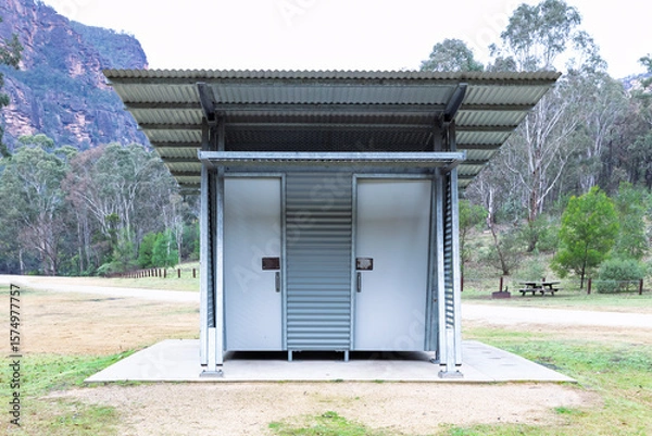 Obraz Photograph of a reasonably well maintained steel and corrugated iron unisex toilet block on a concrete base located in a large public use campground facility.
