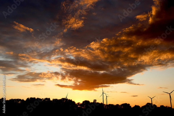 Obraz Wind turbines silhouette at sunset with dramatic sky