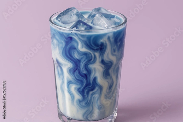 Fototapeta Iced blue latte with swirling patterns in glass, creative colorful dairy beverage on pastel lilac background, trendy refreshing drink