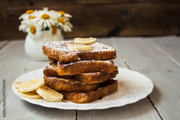 Fototapeta french toast with bannana on wooden background