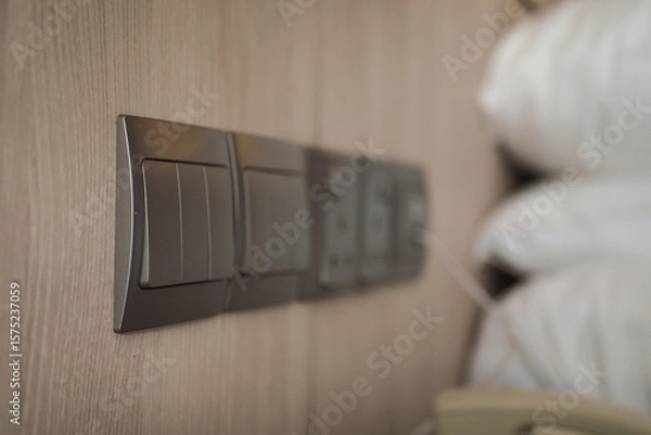 Fototapeta Light switches and power outlets in a cozy bedroom setting