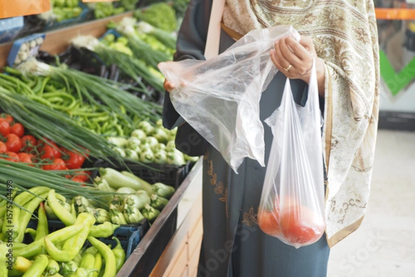 Fototapeta Shopping for fresh vegetables at a local market