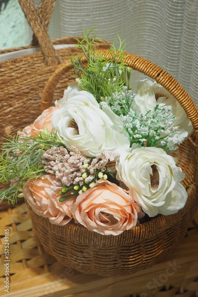 Fototapeta Beautiful floral arrangement in a wicker basket for decor