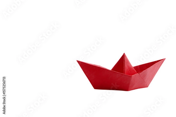 Fototapeta A small red paper boat on a black background.