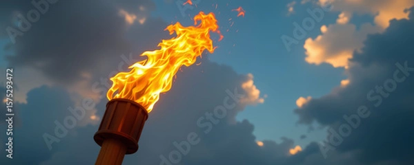 Fototapeta Powerful bright torch flame burning against cloudy blue sky creating dramatic and intense outdoor atmosphere