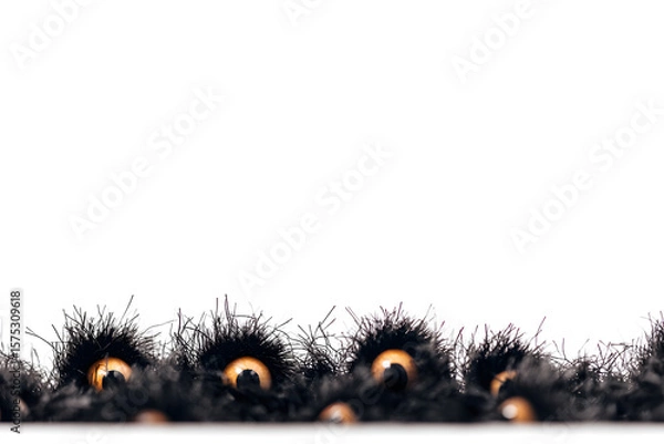 Fototapeta Spooky eyes peeking through the shadows with a halloween border for a frightful effect.
