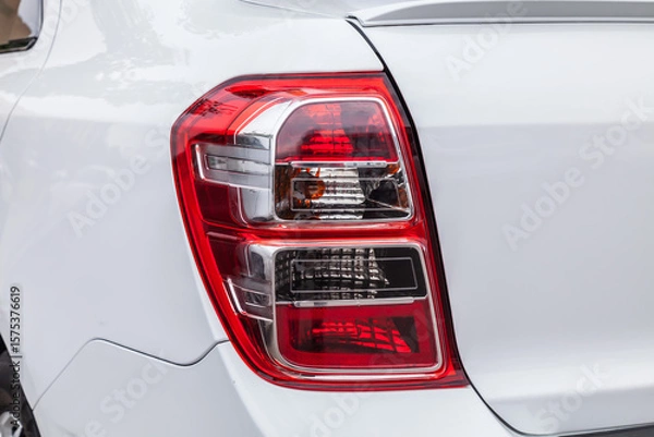 Obraz The back of a white car with a red tail light
