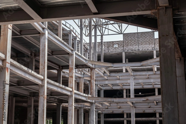 Obraz Large, empty building with a lot of exposed steel beams