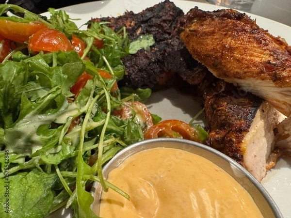 Fototapeta Succulent barbecue chicken with sauce and salad