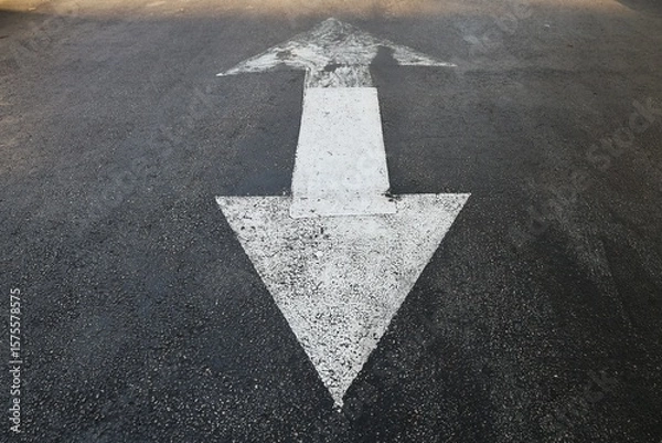 Fototapeta Two sides triangle arrow sign on the road asphalt