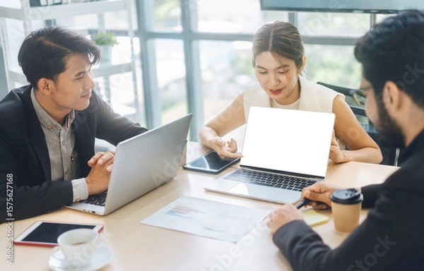 Obraz Business working woman using laptop mockup blank screen on table meeting in office.