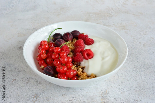 Obraz Healthy Breakfast Bowl with raspberry gooseberry and red currant Berries and Yogurt
