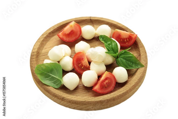 Obraz Italian Caprese salad with cherry tomatoes, mozzarella, basil on wooden plate isolated on white background.