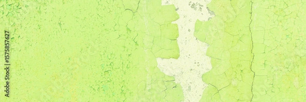 Fototapeta Peeling paint on the wall. Panorama of a concrete wall with old cracked flaking paint. Weathered rough painted surface with patterns of cracks and peeling. Panoramic texture for background and design.