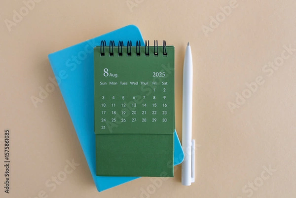 Fototapeta Hello, August 2025. Desktop calendar and notepad for writing on the desktop.