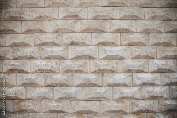 Fototapeta The texture of the wall, lined with curly beige tiles