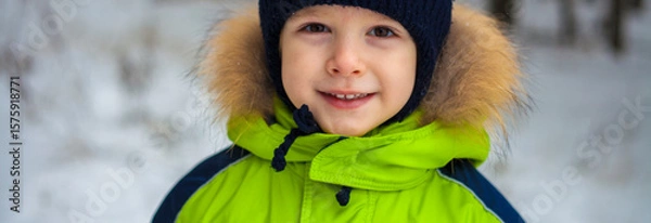 Obraz portrait of a little boy in a hat and jacket in winter