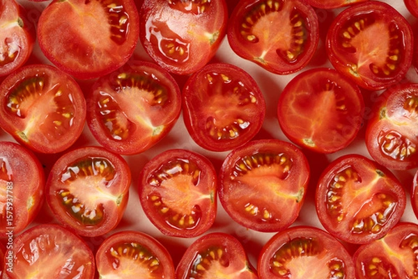 Fototapeta Small ripe tomatoes cut into halves macro top view